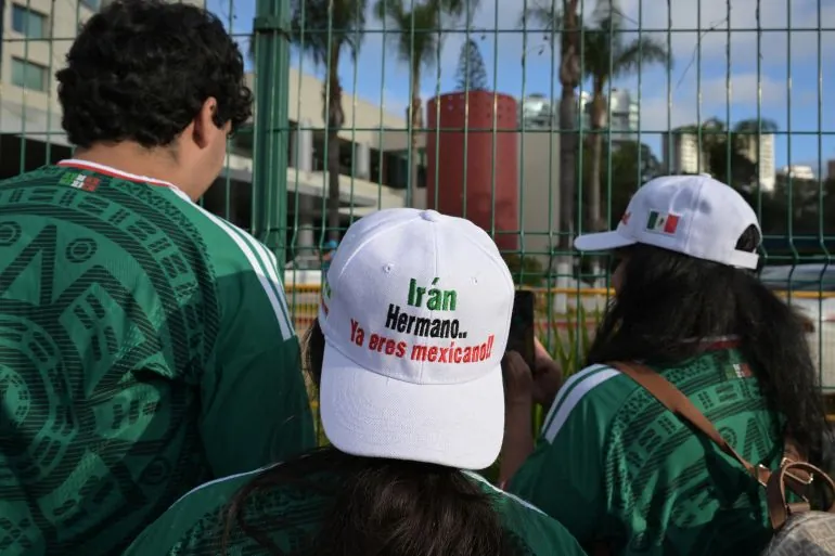 Iran fans wear caps reading Iran, brother, youre Mexican now while waiting for the team at the Marriott Hotel in Tijuana, Mexico, on June 27, 2026. (Photo by Guillermo Arias / AFP)
