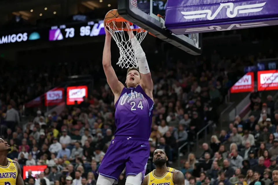 Feb 12, 2025; Salt Lake City, Utah, USA; Utah Jazz center Walker Kessler (24) dunks against Los Angeles Lakers forward Lebron James (23) during the second half at Delta Center. Mandatory Credit: Chris Nicoll-Imagn Images