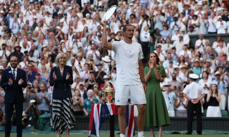 Germany's Alexander Zverev celebrates with the runner-up trophy after his final match against Italy's Jannik Sinner as Britain's Catherine, Princess of Wales looks on at All England Lawn Tennis and Croquet Club, London, Britain on July 12, 2026.