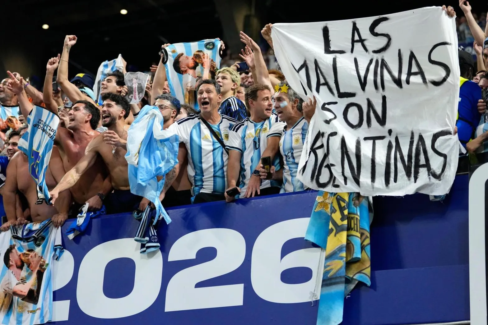 Argentina fans hold a banner with the words "The Malvinas are Argentinian."