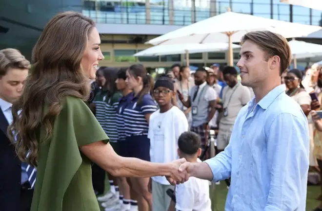 Princess of Wales (L) meets with Britain's semi-finalist Arthur Fery (R), as she arrives to attend the men's singles final tennis match