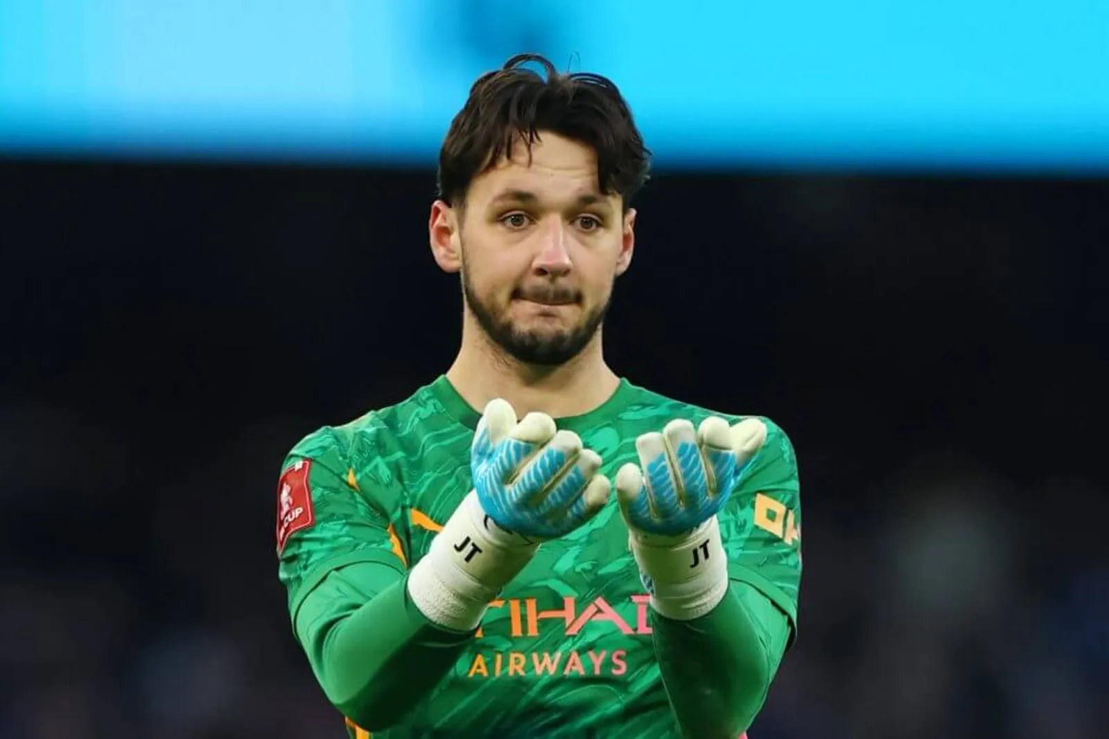 Trafford with his arms out